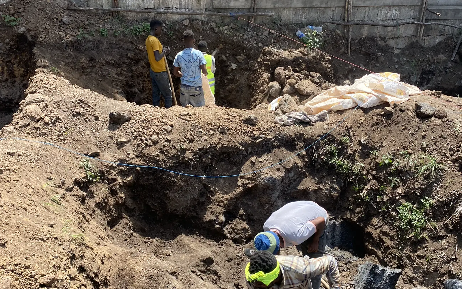 Construction team carrying out excavation and setting-out work
