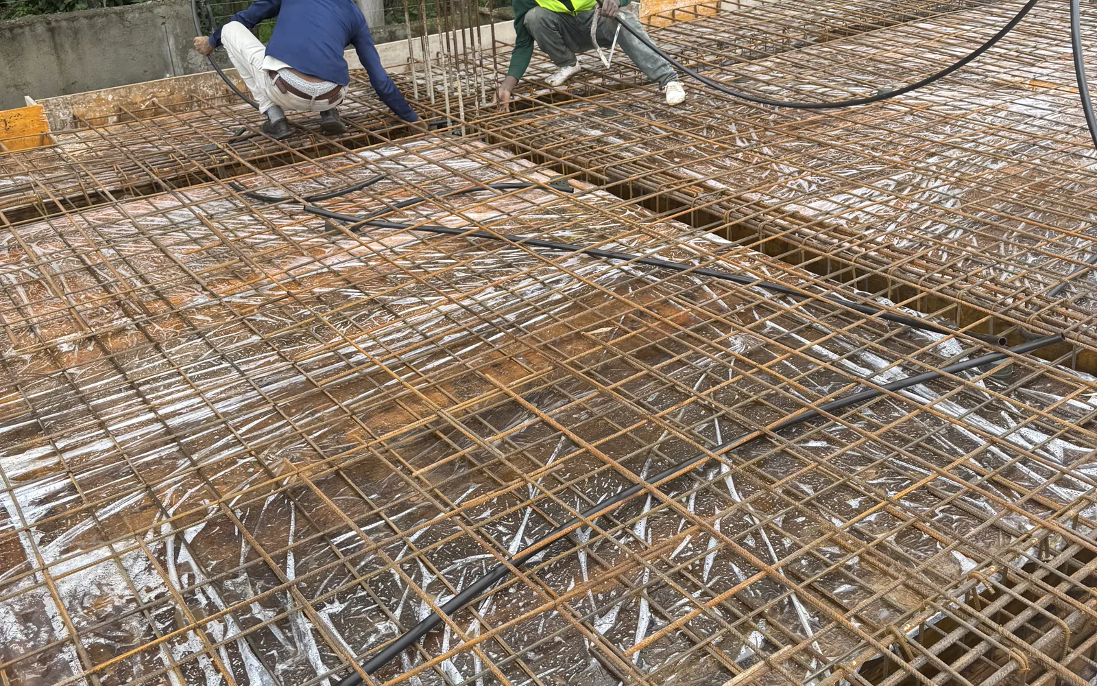Construction team working on dense slab reinforcement